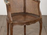 a wooden chair with a woven seat on a wooden floor