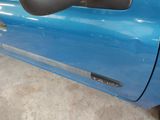 a close up of a blue car door handle