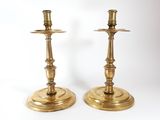pair of antique brass candlesticks on a white background
