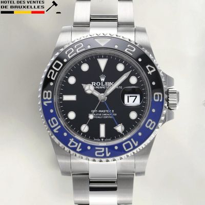 a rolex watch with a blue bezel on the bracelet