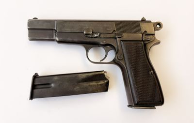 un pistolet et un chargeur posés sur une surface blanche