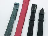 three pieces of black and pink leather watch bands on a white surface