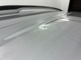 a close up of a car ' s roof with a light shining on it