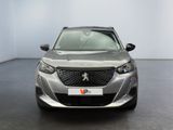 the front view of a silver car parked in a showroom