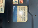 a close up of a laptop with a lot of stickers on it