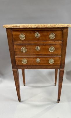 an antique wooden chest of drawers with marble top