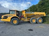 a large yellow dump truck parked in a parking lot