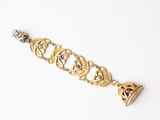 a close up of a gold bracelet with a heart on it