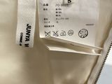 an image of a white jacket with a label on it