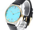 an image of a woman ' s wrist watch with a blue dial
