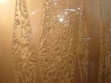 a glass wall with a pattern on it in a room