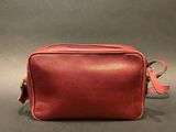 a red leather bag on a grey background