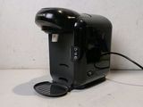 a black coffee maker sitting on a counter top