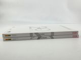 two books are stacked on top of each other on a white surface