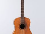 a close up of a wooden guitar on a white background