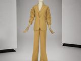 un mannequin vêtu d'un costume beige dans une pièce