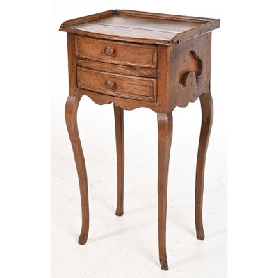 a small wooden table with a drawer on it