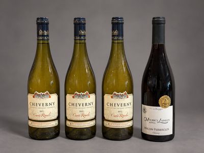three bottles of wine are lined up on a table