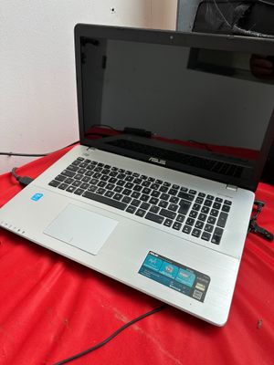 an open laptop computer sitting on top of a red sheet