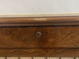 a close up of a wooden cabinet with a glass door