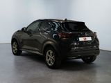 the back of a black car is parked in a white room
