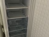 a white refrigerator with its door open in a kitchen