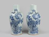 pair of blue and white vases with flowers and birds on them