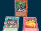 three cards are sitting on a table with a blue background