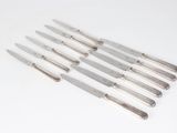 a set of six silverplated knives with a handle