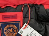 the jacket is red and black with a badge on it