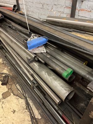 a pile of steel pipes sitting on the ground
