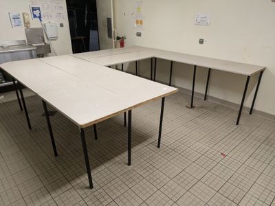 a room with tables and chairs in it that are empty