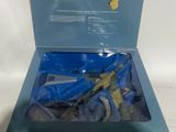 the box is open to show the contents of a toy gun