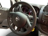 steering wheel and dashboard of a small car with a clock on the dash