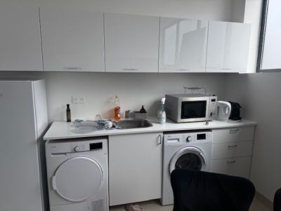 a kitchen with a washer and a dryer in it