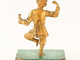 brass figurine of a man on a green marble base