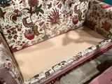 a couch with a floral pattern on it in a room