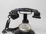 a black telephone that is sitting on a white table