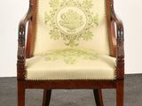 an image of a wooden chair with a green and white upholstered seat