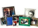 many different pictures of a man in a suit and tie on a table