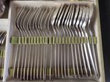a lot of forks and spoons that are in a box
