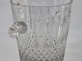 a glass vase with a handle on a table