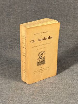 an old book sitting on top of a table on a gray surface