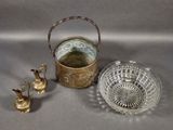 three pieces of glass and brass on a gray surface