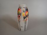 a white vase with a red and yellow design on it