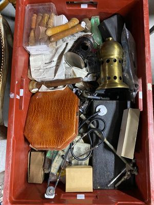a red box filled with assorted items sitting on a table