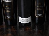 several bottles of wine are lined up on a table