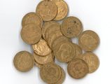 une pile de pièces d'or posée sur une surface blanche