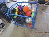 a blue shopping cart filled with assorted balls