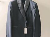 a suit hanging on a hanger on a wall